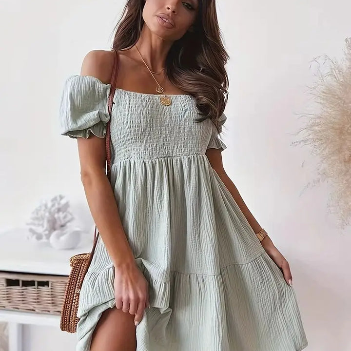 Off-shoulder ruched midi dress.